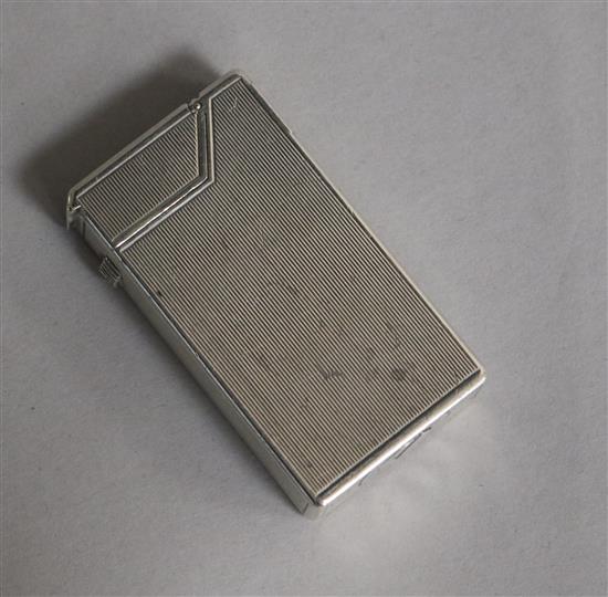 A Dunhill engine-turned silver cigarette lighter, patent no. 440072, London, 1948, 59mm.